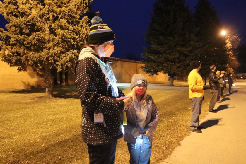 A mother and daughter joined CARE members to show support for teachers and students during the coronavirus pandemic on Tuesday, Dec. 8 outside of Fargo South High School.jpg