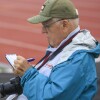 man writing notes on a pad of paper