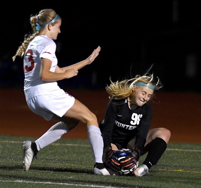 Duluth Denfeld keeper Cayley Larsen (98) stops the ball in front of Duluth East’s Grace Karakas (13)