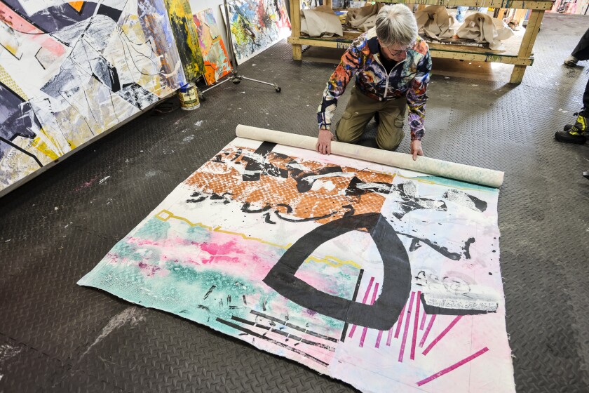 A family creates abstract paintings together in a home studio