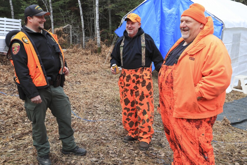 people in bright orange deer hunting