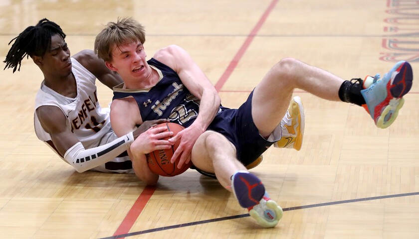 Players wrestle for ball on floor.