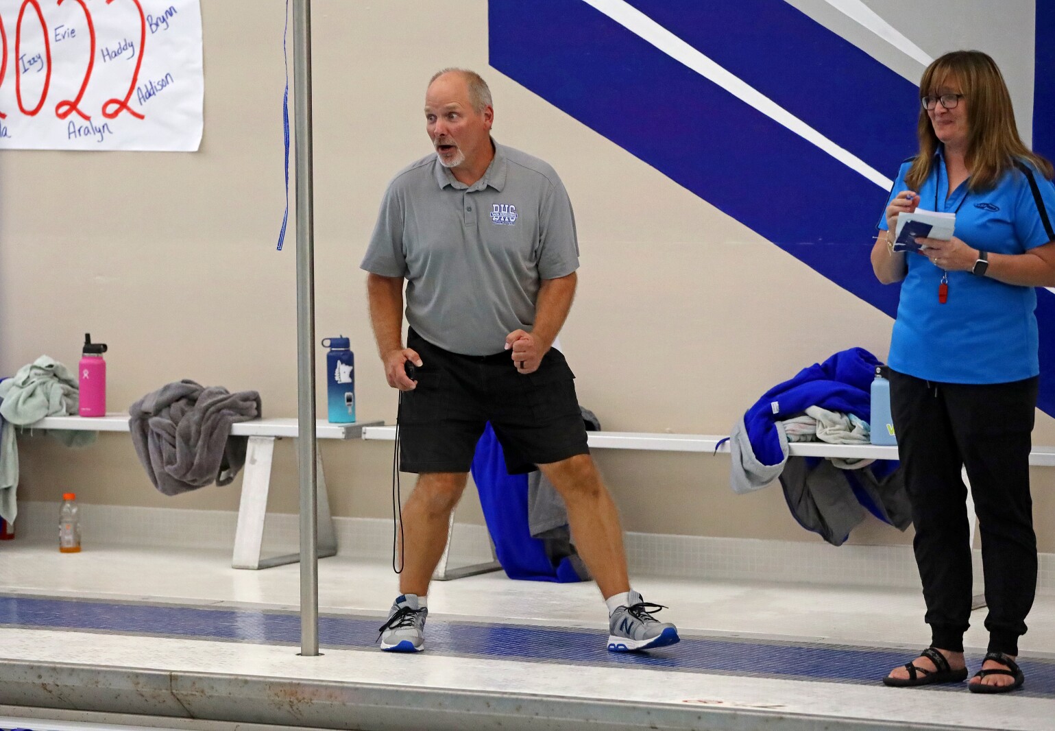 Swim coach Dan Anderson at the side of the pool.