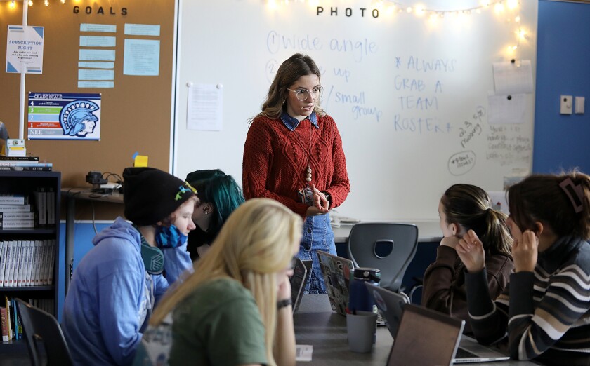 First-year teacher Elise Hintzman talks to some of her students in her Reading, Writing and Reporting class at Superior High School