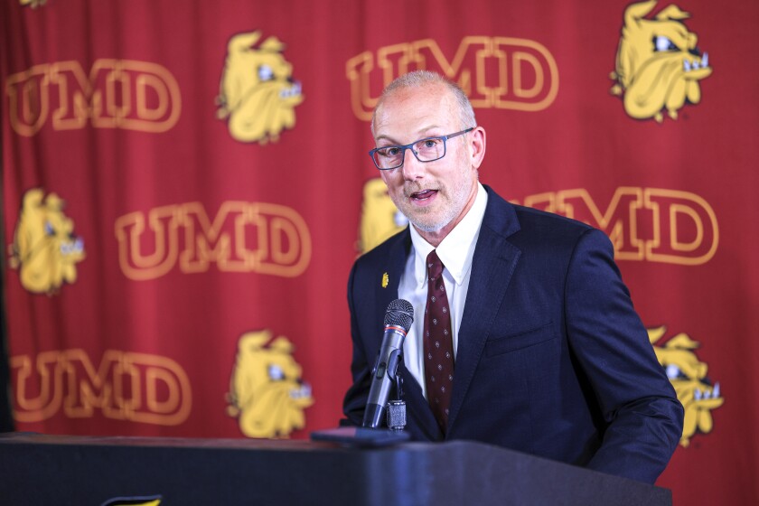 people at podium during press conference