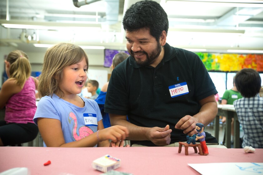Ceramic artist Guillermo ("Memo") Guardia teaches Ella Muth, 7, Grand Forks, the art of working with clay at the NDMOA's Summer Art Camp at the UND Hughes Fine Arts Center Monday. (Photo by Eric Hylden/Grand Forks Herald)