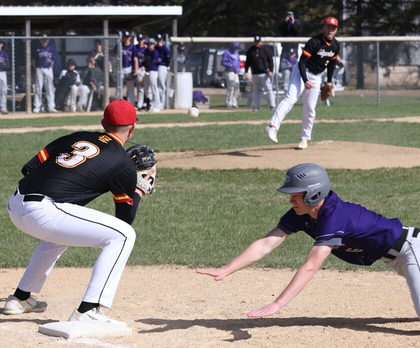 Murray County Central's bench watches as Edgerton High School Flying Dutchmen pitcher Skyler Feikema throws to first baseman Trevin Prins (3) in an attempt to catch Rebels Adan Dierks (6) off base during a Monday afternoon game in Edgerton.