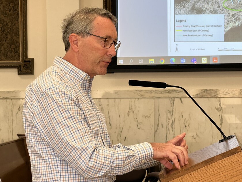 Attorney speaks at the microphone in the Crow Wing County Boardroom