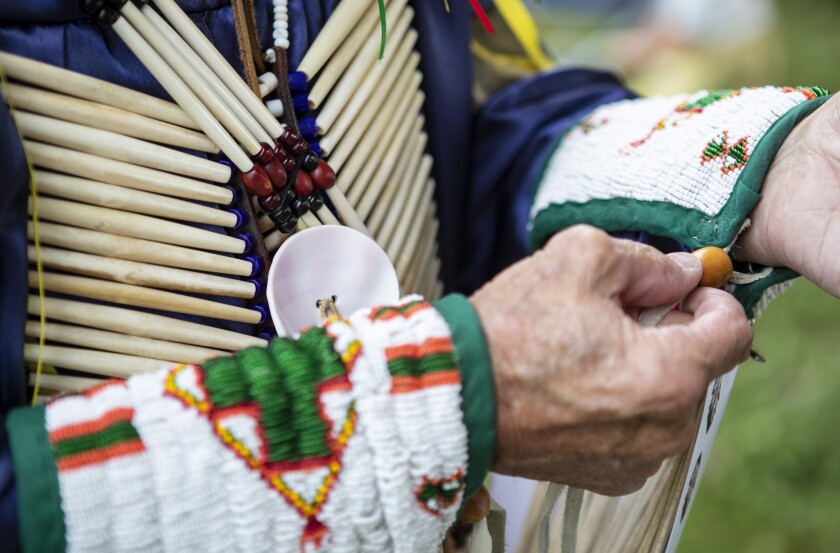 Granite Falls resident Michael Yeomans attaches pieces of his regalia while preparing to take part in the Upper Sioux Community's traditional Wacipi on the evening of Friday, August 5, 2022.