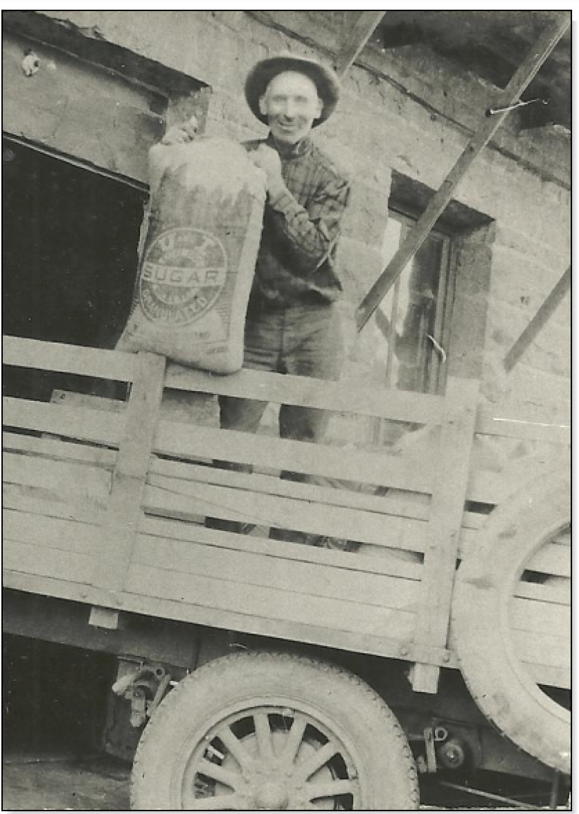 A man holds the first bag of sugar produced in South Dakota.