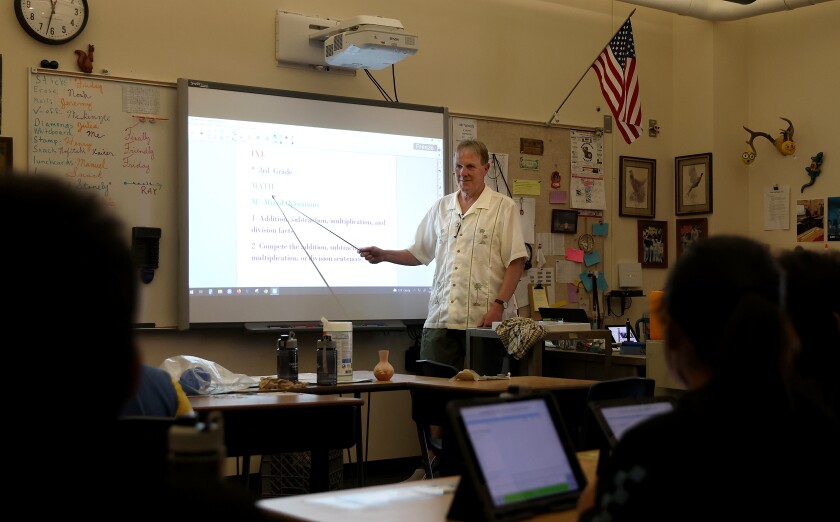 Prairie Elementary teacher Tom Woods reviews a lesson with his students on Friday, May 20, 2022.