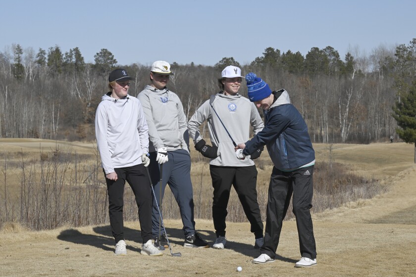 Brainerd Warrior golf captains Drew Haakonson, left, Henry Hartwig and Tyler Lehmann watch Treydn Hendrickson hit a ball at the Gravel Pit Golf Course on Monday, March 31, 2025, in East Gull Lake.