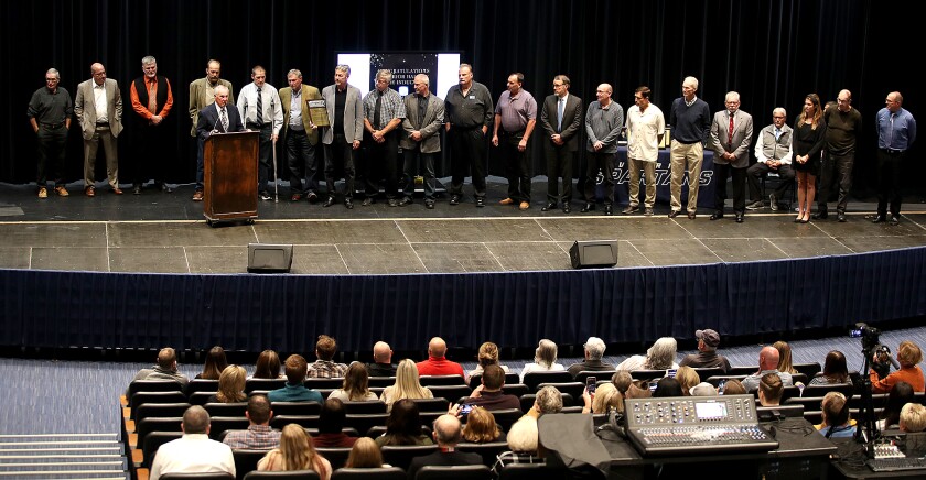 Former Head Spartan football coach Larry Hoff speaks from the podium about his players on the 1976 football team during Superior High School’s Hall of Fame Induction Ceremony