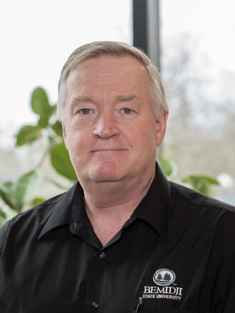 A photo of a man smiling.