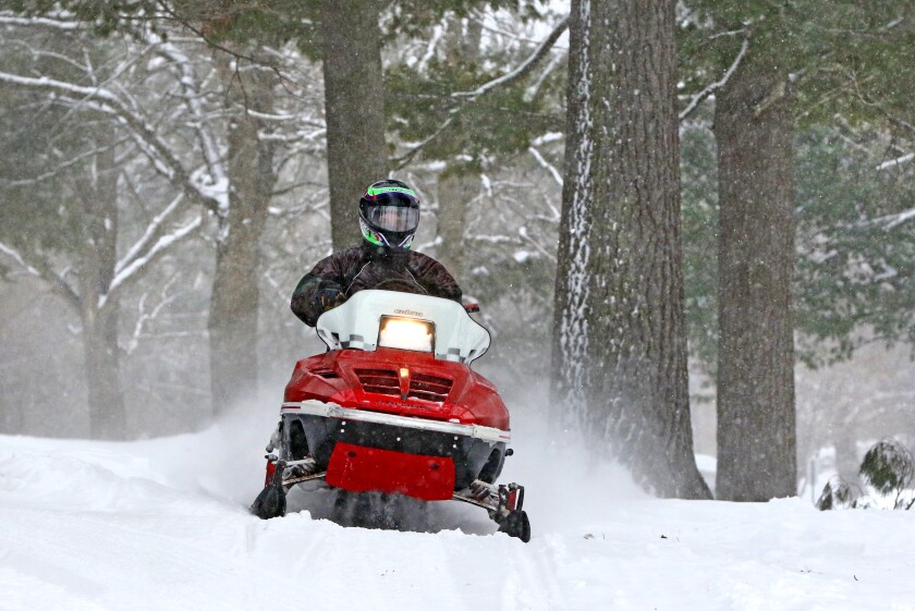 A snowmobiler rides through Lum Park to get to Rice Lake Sunday, Feb. 10, in Brainerd. Kelly Humphrey / Brainerd Dispatch