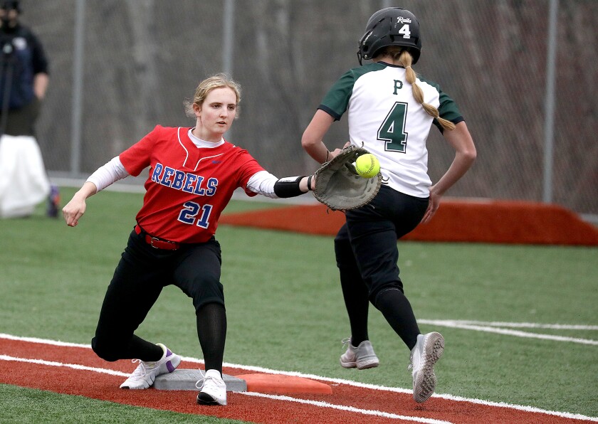 Moose Lake’s Sandra Ribich (21) makes a catch at first base as Proctor’s Sophie Parendo (4) is called safe