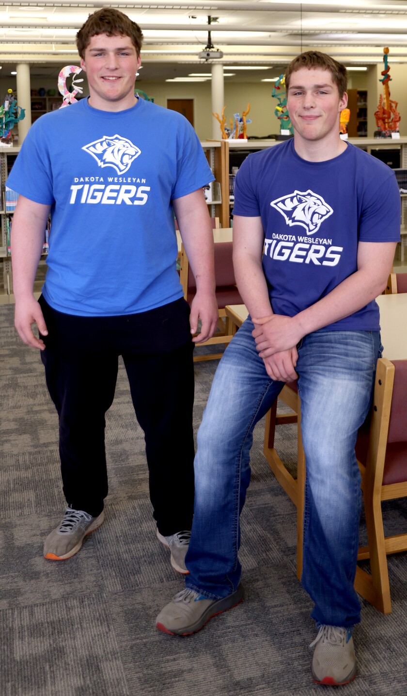 Worthington Trojans Cole (on left) and Tanner Hennings signing this week to continue their wrestling careers at Dakota Wesleyan University.