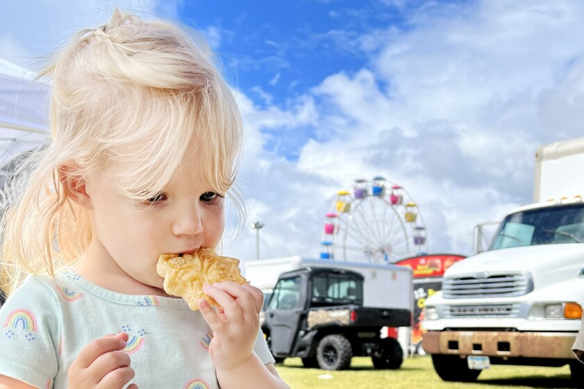 girl eating at fair