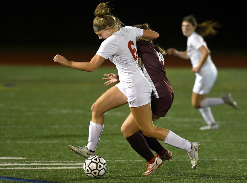 Duluth East’s Riley Brett (6) moves the ball up the field