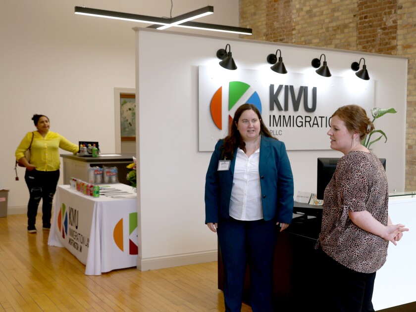 Legal Assistant Leah Ward (center) greets during an Open House for the new location of the Kivu Immigration Law PLLC located at 222 10th Street in downtown Worthington.