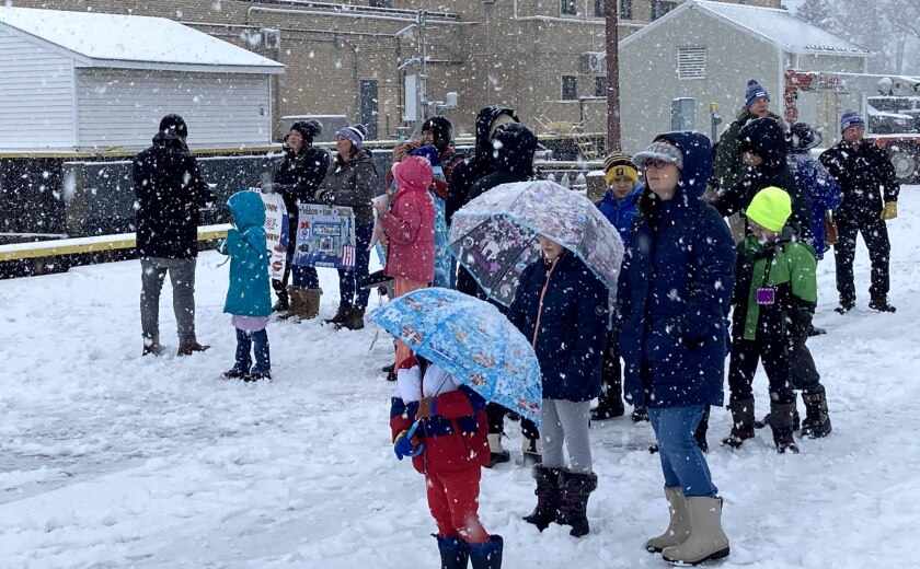 people gather to welcome crew members of vessel to Duluth