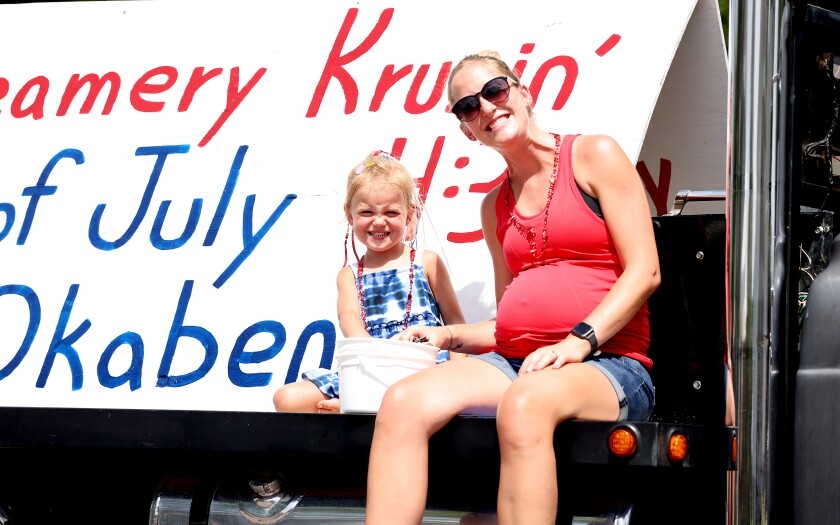 Participants in Okabena's Independence Day parade pose for the camera as they take a break from throwing candy to the crowd Monday afternoon, July 4, 2022.