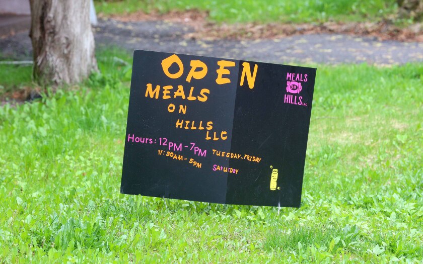 A sign for Meals on Hills