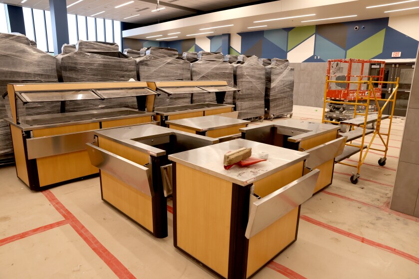 Cafeteria tables wait to be unwrapped and buffet counters are still being assembled in the new Intermediate School, as seen Friday, June 10, 2022.