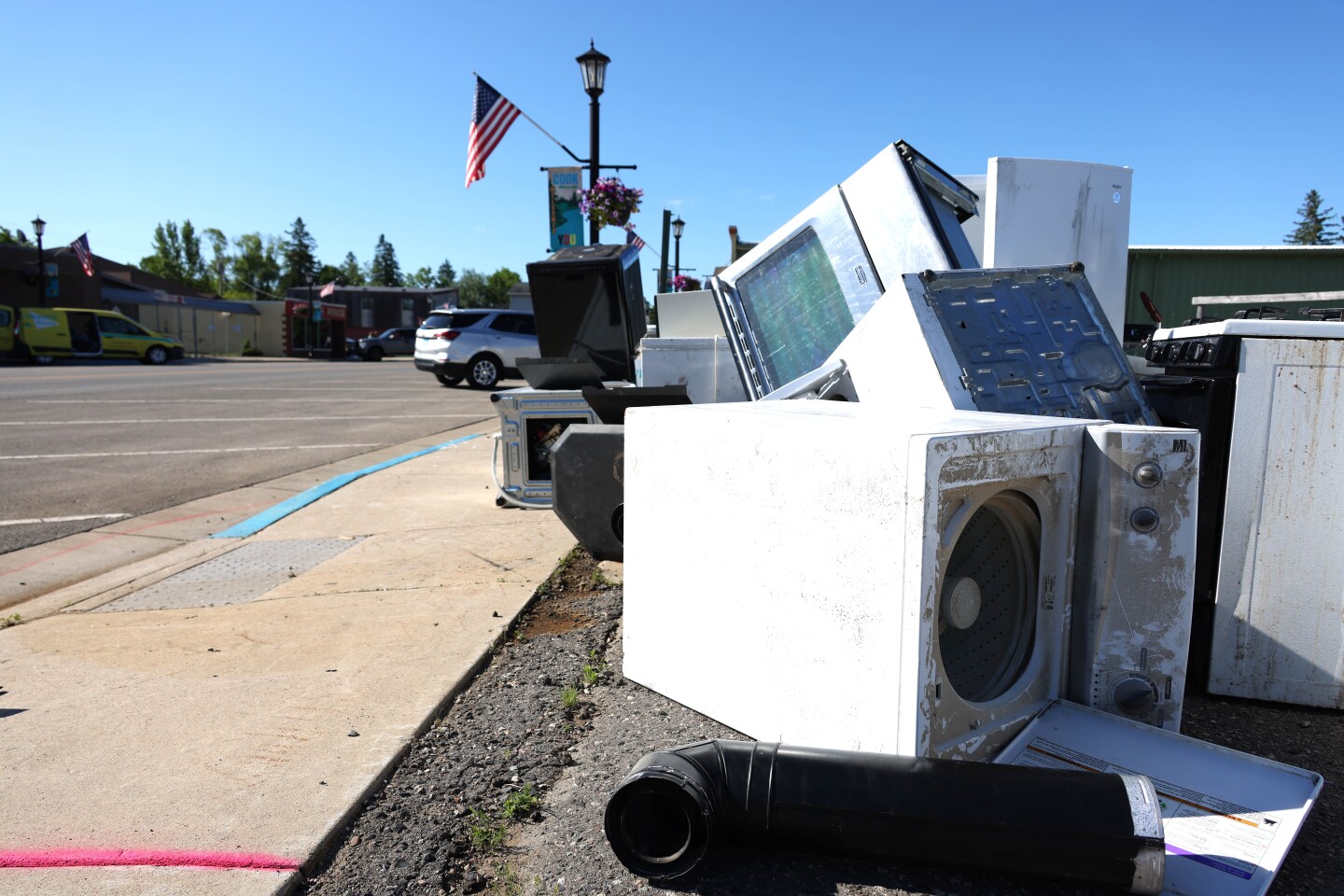Flood damaged appliances piled on the side of the road