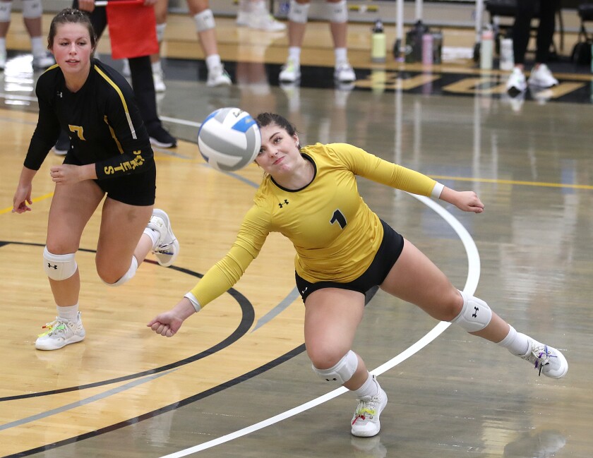 UW-Superior’s Jenna Anderson (1) dives to save a ball as she’s backed up by Hailey Atwood (7)