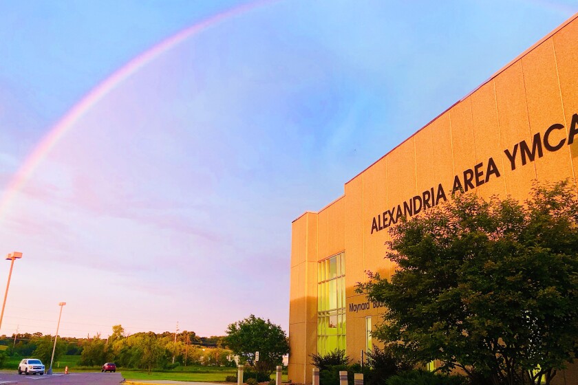 YMCA with rainbow at sunrise