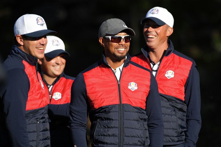 Sep 27, 2016; Chaska, MN, USA; Team USA vice captain Tiger Woods shares a laugh with Team USA players Brooks Koepka , Patrick Reed and Matt Kuchar before their official photo on the 10th Fairway at Hazeltine National Golf Club ahead of the 41st Ryder Cup. Mandatory Credit: Michael Madrid-USA TODAY Sports
