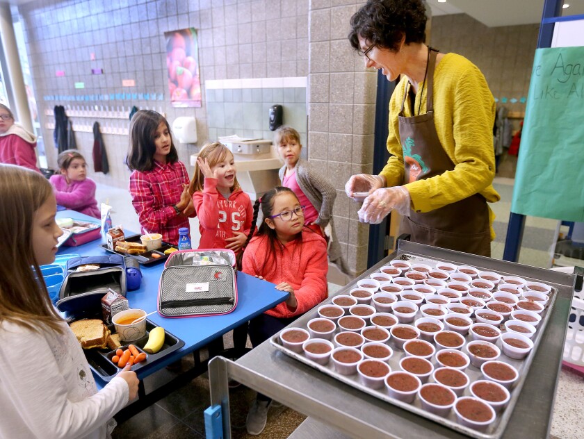 Renee Willemsen, farm to school coordinator, serves up healthy kale smoothies to Lester Park School second graders during a recent lunch period. Bob King / rking@duluthnews.com