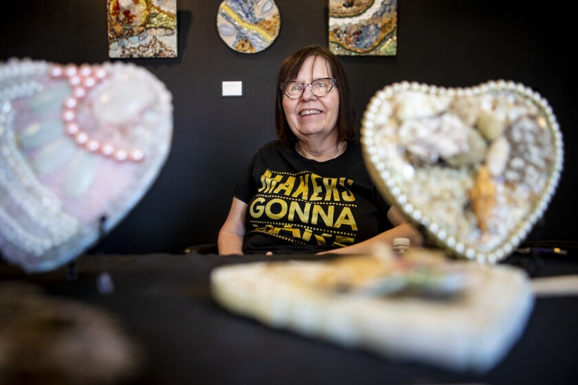 Artist Jean Trumbo poses for a portrait with her artwork at the Little Theatre in New London during Studio Hop on Friday, June 17, 2022.