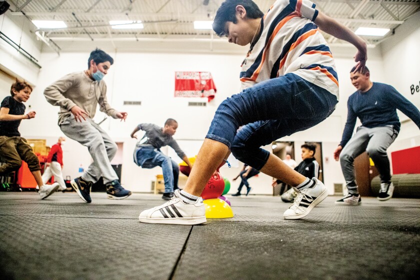 Carlin Pasos, 14, and classmates rush a row of dodgeballs as a game begins at Willmar Middle School