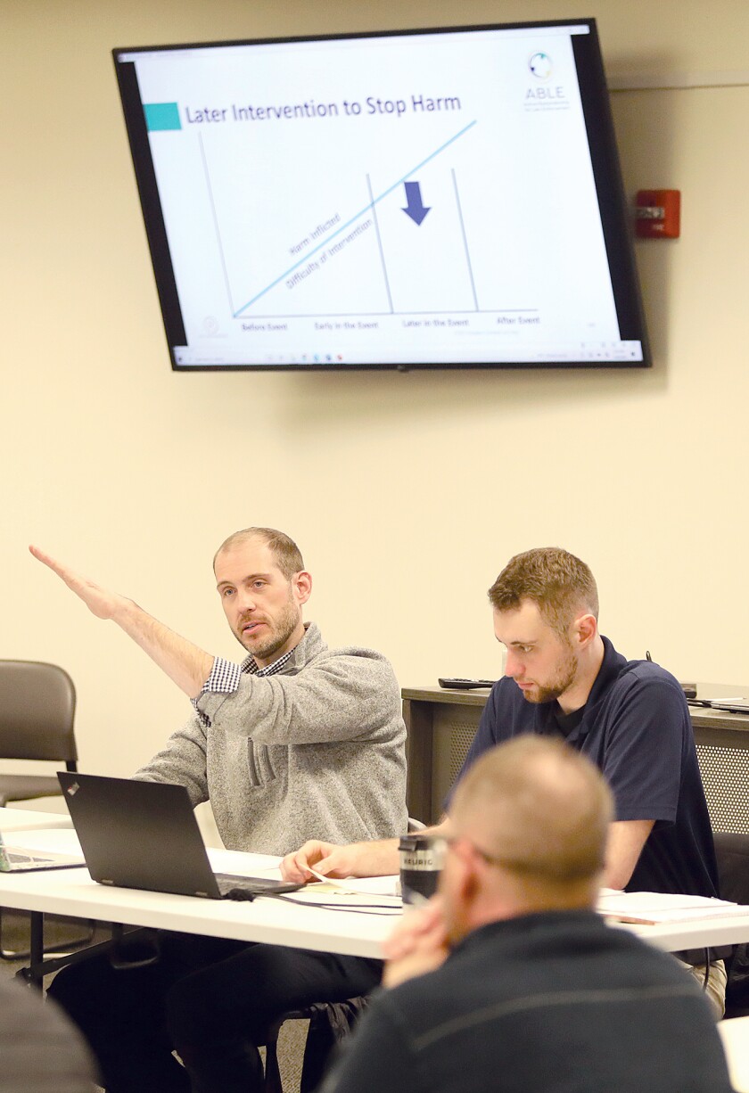 Superior Police Sgt. Matt Brown, left, talks about intervention points during the Active Bystandership for Law Enforcement (ABLE) project training
