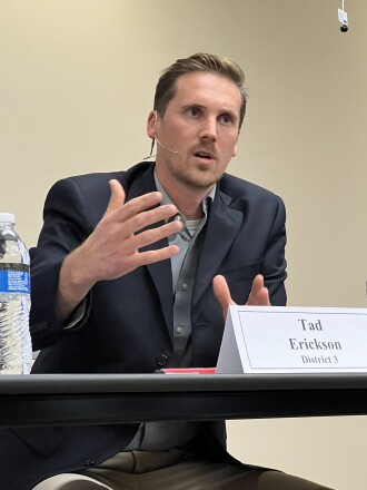 Candidate speaks while seated at table