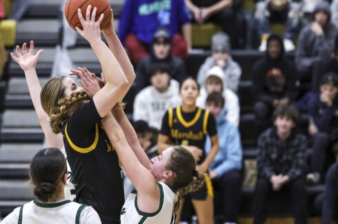 high school girls play basketball