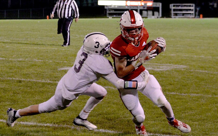 Willmar junior Dylan Staska, right, runs for the sidelines while Delano's Mason Henry goes for the tackle during a North Central White District game on Friday, Sept. 30, 2022 at Hodapp Field.
