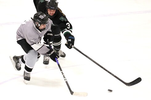 Players race to puck.