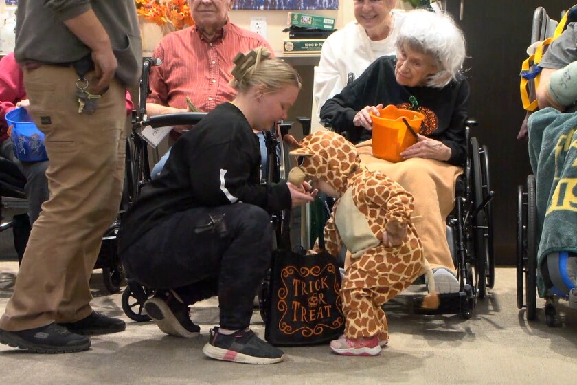 seniors and children celebrating Halloween - Fargo seniors hand out candy and smiles at Eventide's annual ...