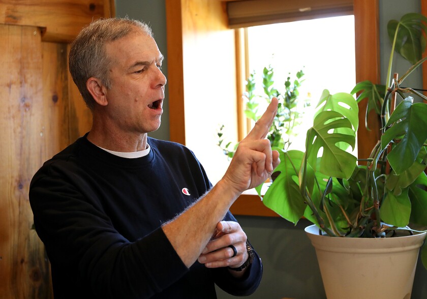 Artist Steven Peterson uses sign language to tell a story