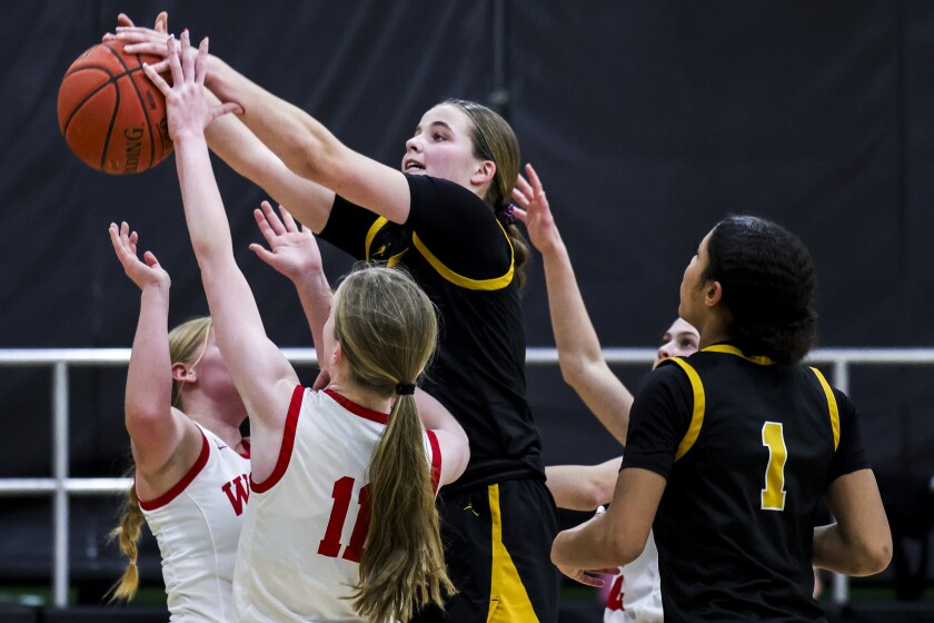 high school girls play basketball