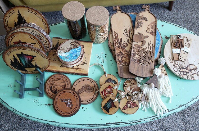 Wood burned items sit on a table.