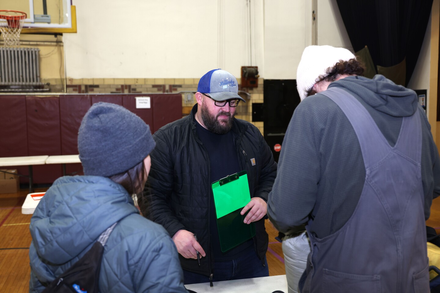 Race volunteer helps racer check gear bag
