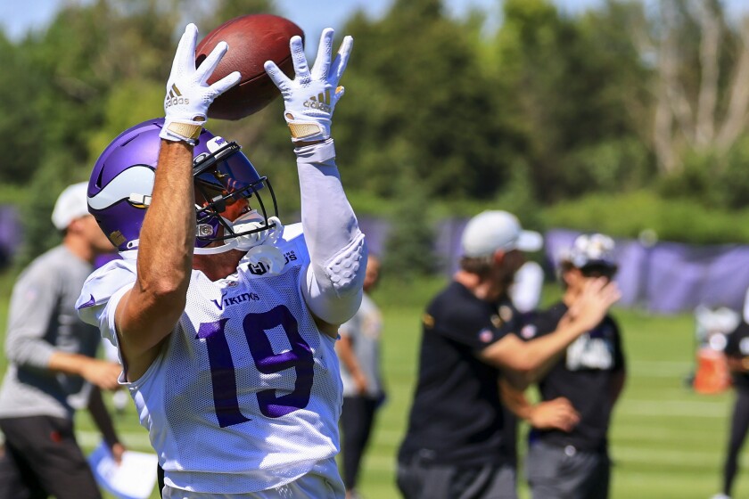 Professional football players practice at outdoor field