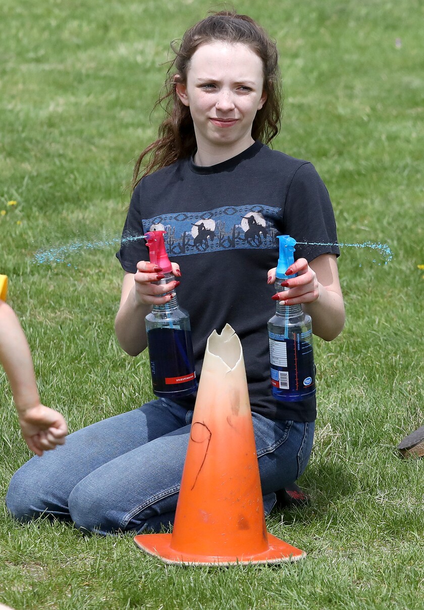 Purdee Toland sprays runners with colored water