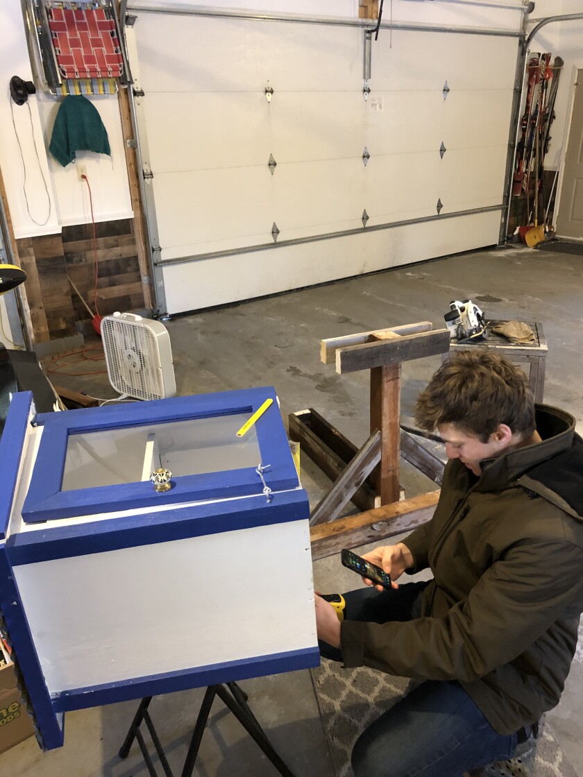 Sean Baumann works on building the Brainerd Junior Jaycees Little Free Library at his house