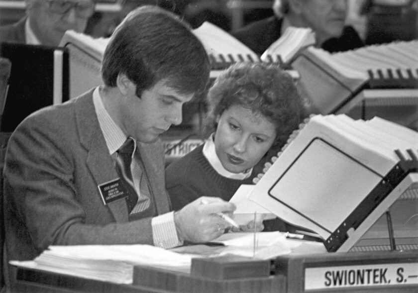 Old photo, couple looking at printed materials
