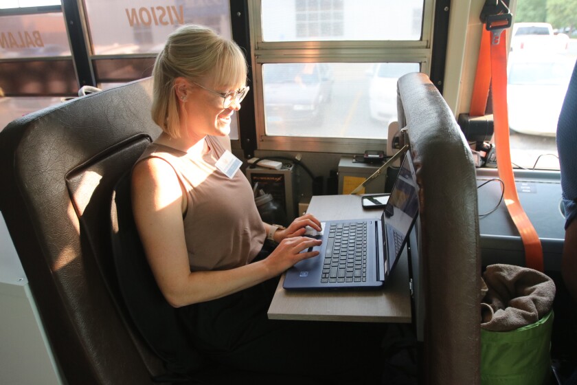 Stacey Reek, a physical therapist, working on her computer inside the Beyond Boundaries Therapy bus in Milnor, ND.jpg